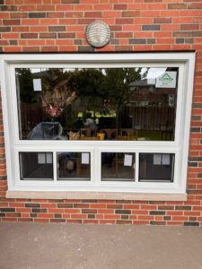 White vinyl window installed in a modern home, showcasing durability and energy efficiency, part of EcoTech Windows and Doors' replacement options