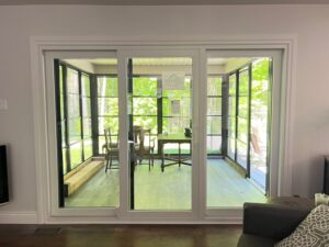 Elegant white patio door from EcoTech Windows & Doors, flooding the room with natural light and enhancing the indoor-outdoor connection.