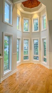 The alt text for multiple white windows in a dome for EcoTech could be: Multiple white windows in a dome-shaped structure installed by EcoTech Windows and Doors, showcasing their quality craftsmanship and elegant design.