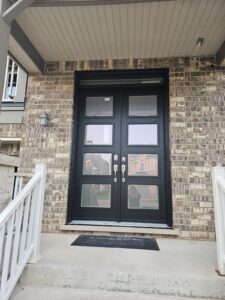 Modern black fiberglass door with a smooth finish, emphasizing its durability and contemporary design.