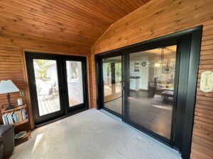 Sunroom with EcoTech patio door, welcoming natural light and outdoor views.