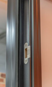 Close-up view of the dual weatherstrips on the EcoTech High Performance Entry Way Door System, highlighting the continuous air weatherstrip for superior protection against drafts and water infiltration.