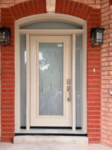 A vibrant red exterior door featuring a stylish verso v-groove glass design, enhancing the home's entryway with a modern and elegant look, offered by EcoTech Windows and Doors.