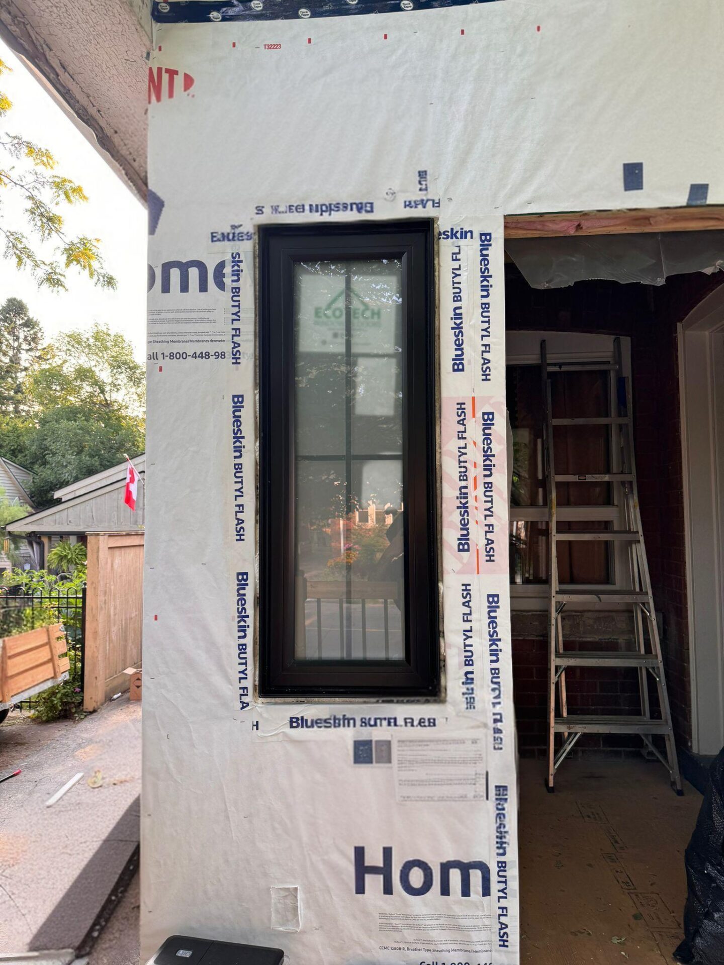 New construction home with EcoTech windows, framed with construction paper to highlight the window installation and energy-efficient design.