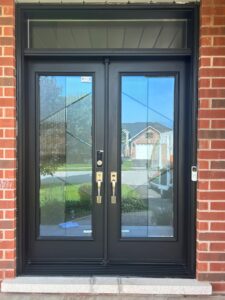 Close-up view of a sleek, modern fiberglass entry door by EcoTech, showcasing its smooth surface and stylish design.