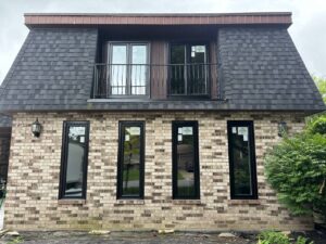 Exterior view of a home showcasing multiple Canadian windows from EcoTech Windows and Doors, highlighting modern design and energy-efficient features.