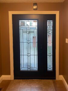 An elegant stained glass door featuring intricate patterns and vibrant colors, adding a classic and artistic touch to the entryway, showcased by EcoTech Windows and Doors.