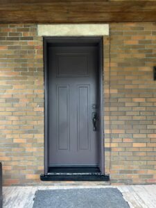 Black fiberglass entry door by EcoTech with a sleek, modern design and smooth finish.