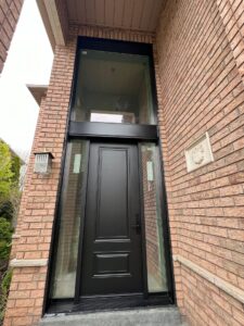 Front door with a large transom window above, adding an expansive flow of natural light to the entryway.