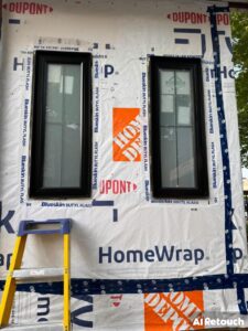 Two EcoTech windows installed in a new construction home, with construction paper applied around the windows to show the framing and insulation work.