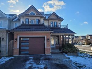 A set of stylish garage doors in a Toronto home, showcasing a modern design that complements the home's exterior and provides functional security.