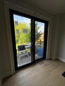 A patio door installation in a Toronto home, featuring a sliding glass door that provides easy access to the outdoor space and enhances natural light.