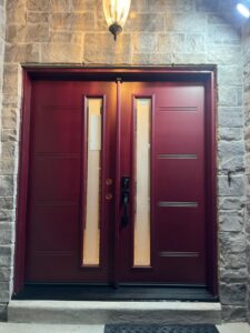 A vibrant red entry door installed in a Toronto home, adding a bold splash of color and enhancing the home's curb appeal.